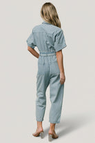 Detail shot of front leg pocket and stitched cuff on the Mateo denim jumpsuit, emphasizing pocket depth and finish.