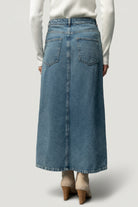 Detailed view of mustard topstitching and denim weave on the Aleksa midi skirt, highlighting finish and construction details.