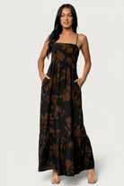 Model wears Regan Tank Maxi Dress in Espresso Print — full-length front view showing tiered chiffon skirt and side pockets.