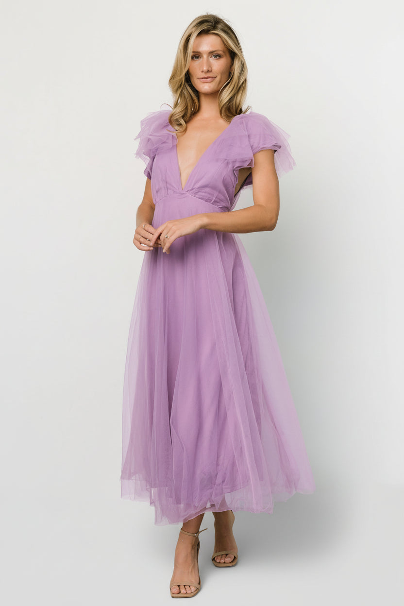 Full-length view of Annabella Tulle Midi Dress in lavender on model, highlighting V-neckline, ruffle sleeves, removable waist tie, and layered tulle skirt.