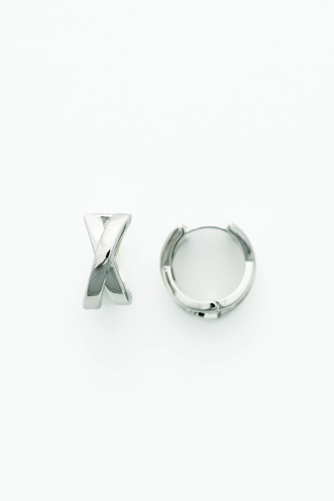 Silver-tone huggie earrings with a polished finish