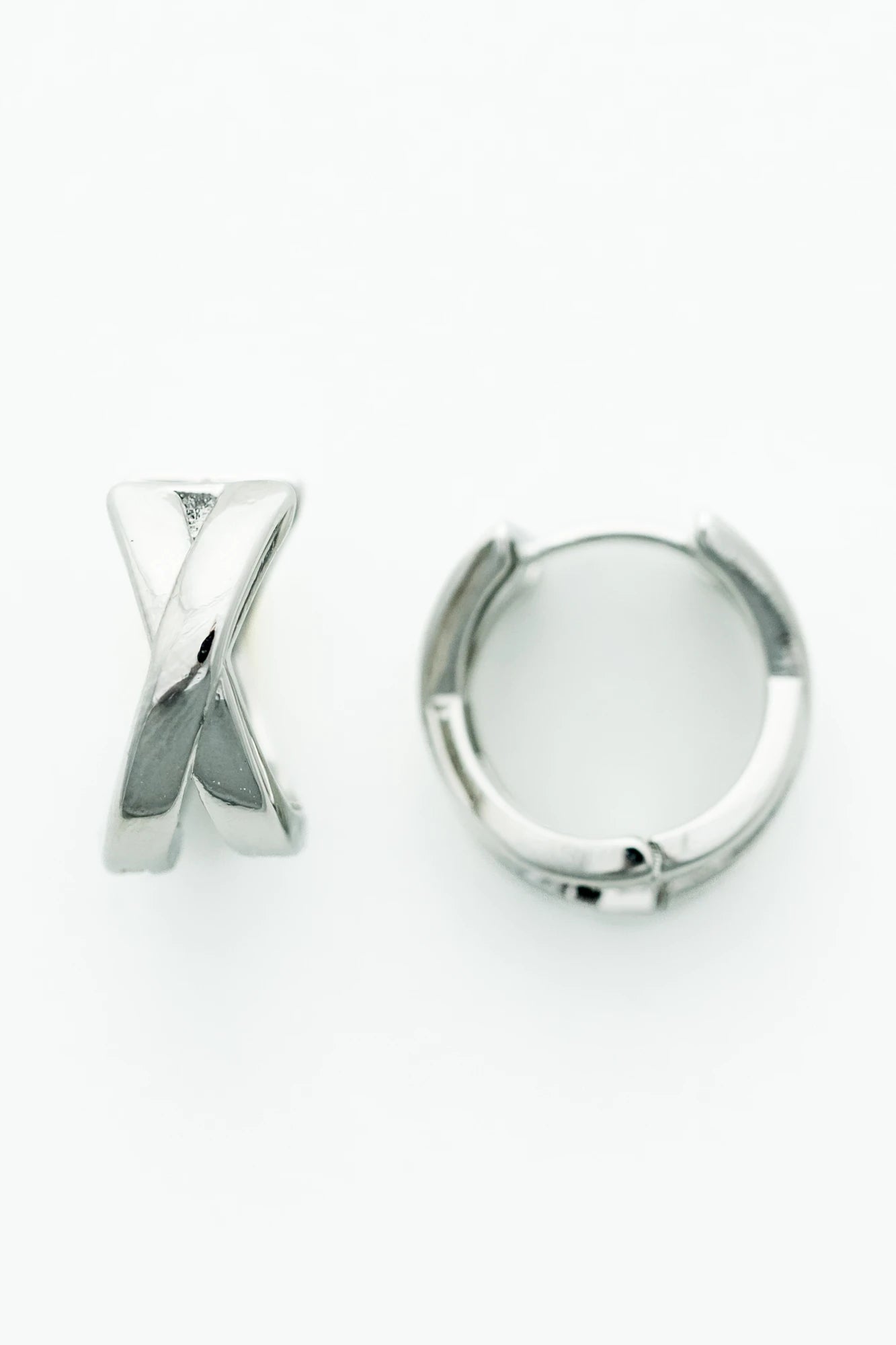 Silver-tone huggie earrings with a polished finish