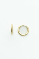 Polished gold-tone huggie hoop earrings featuring a smooth, minimalist finish.