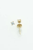 Round crystal stud earrings set in a gold-tone prong setting.
