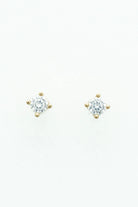Round crystal stud earrings set in a gold-tone prong setting.
