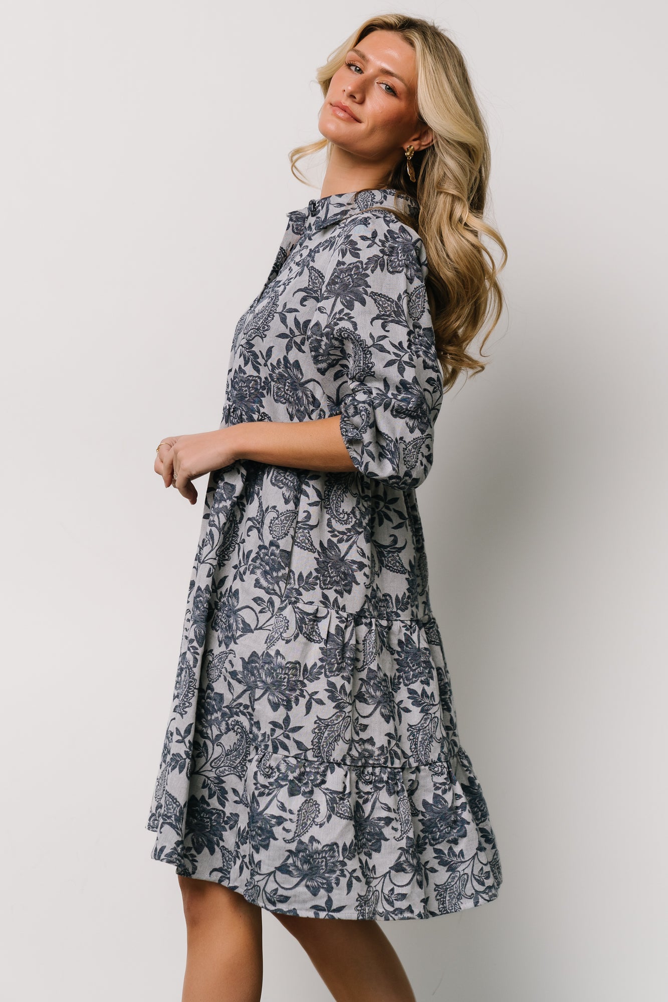 Model pose showcasing the dress length and tiered hem with natural movement; ideal for casual outings or layered looks.