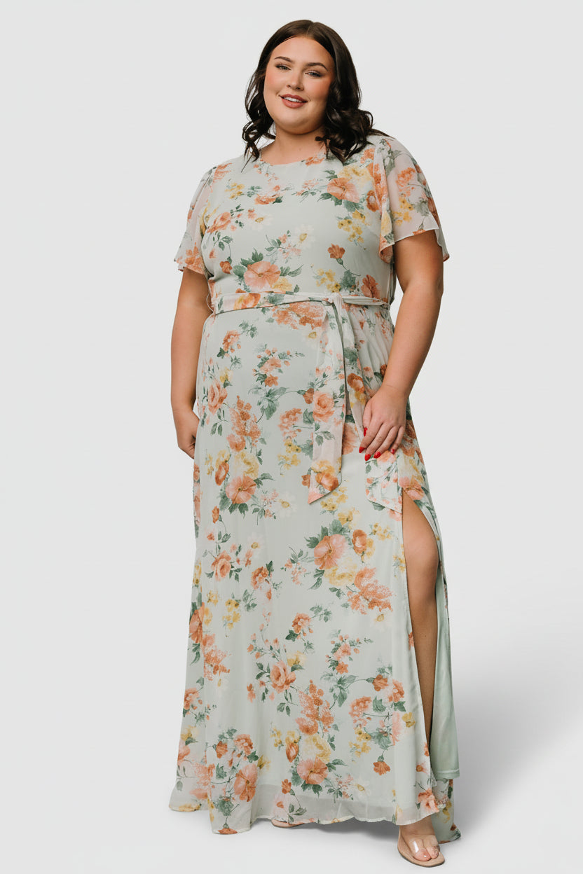 Close-up of bodice detail: rounded neckline, gentle ruching and floral print on lightweight chiffon with the lined body visible.