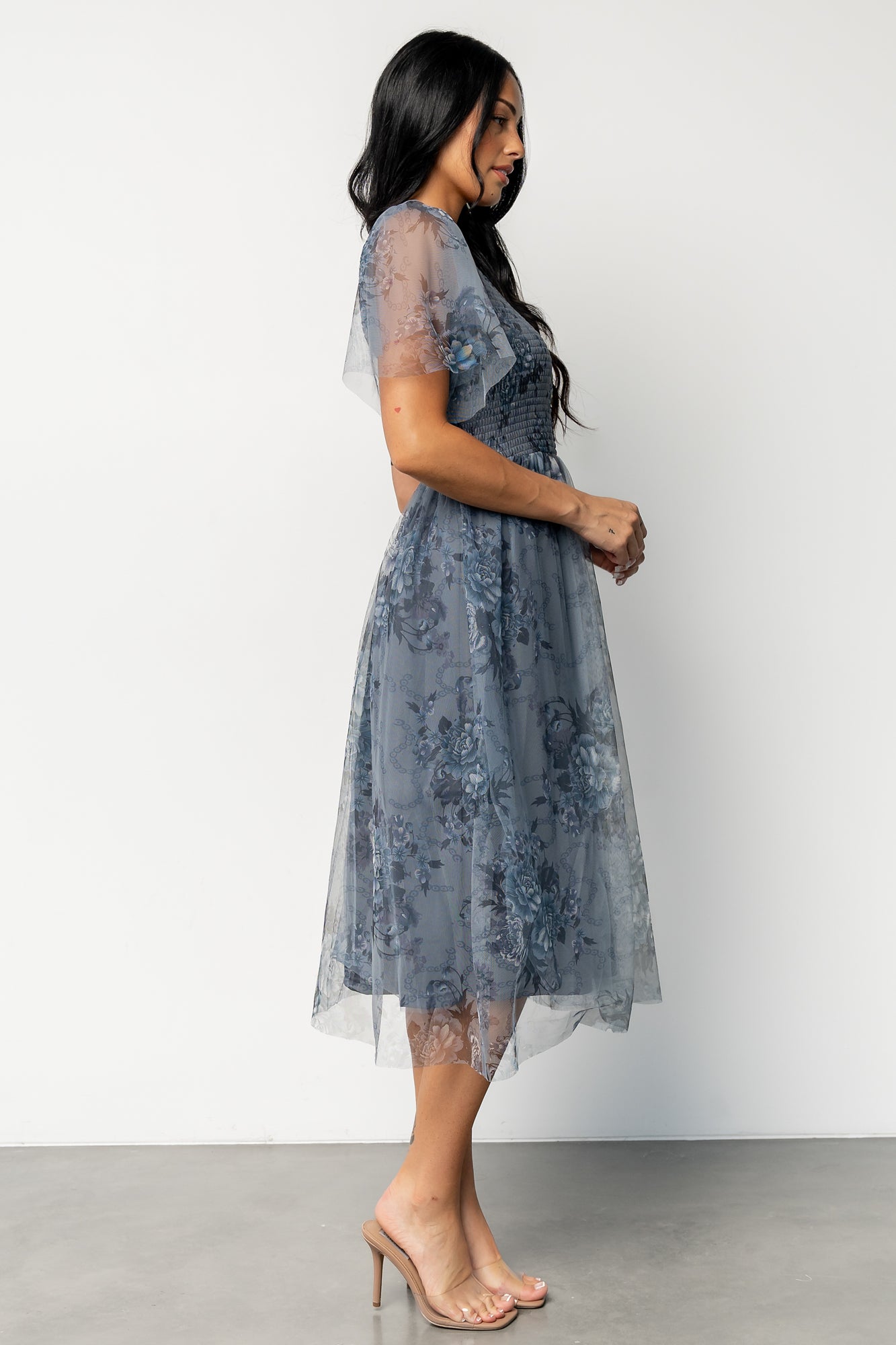 Full-length photo of Josie Tulle Midi Dress in dusty blue floral in motion, highlighting the flowy midi skirt and feminine silhouette.