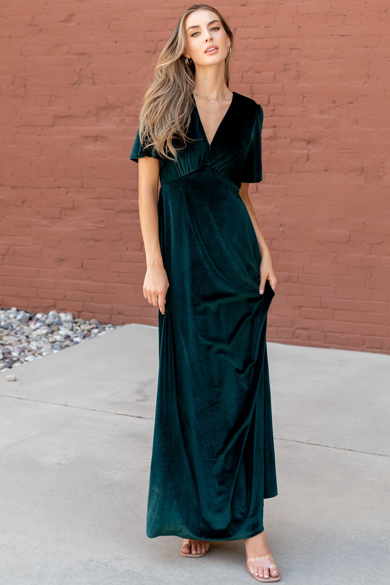 Back view of the emerald Vivian velvet maxi dress highlighting the keyhole closure and graceful back skirt drape.