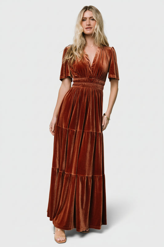 Front view of Artemis Velvet Maxi Dress in Dark Spice showing plunging V-neck, elastic waist, short flutter sleeves, and tiered maxi skirt.
