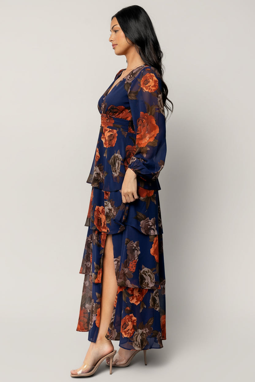 Back view of Mariella Tiered Maxi Dress emphasizing smocked back waistband and gathered tiers for flexible fit and feminine shape.