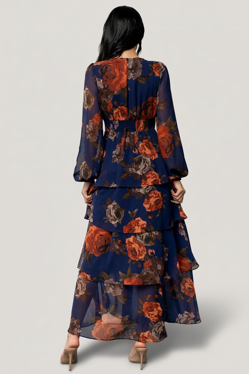 Side view of Mariella Tiered Maxi Dress showing cascading ruffles, maxi length and flowing chiffon movement in navy and rust floral print.