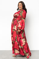Model movement shot wearing Katinka Wrap Maxi Dress in burgundy multi floral showing the flowing chiffon skirt in motion, ideal for events.