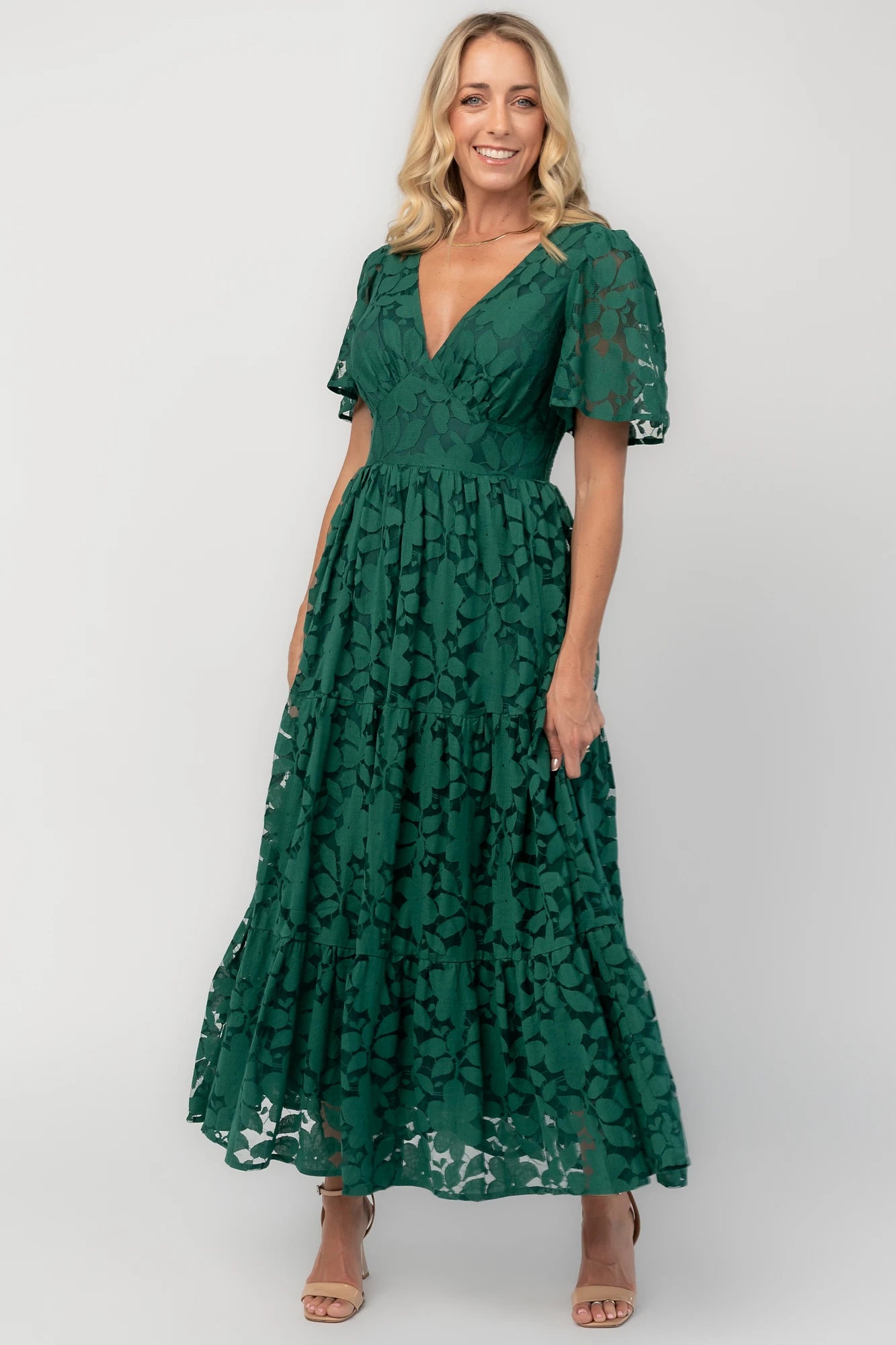 Floral lace midi dress with a deep V-neckline, short flutter sleeves, smocked back bodice, defined waistband, and tiered skirt.
