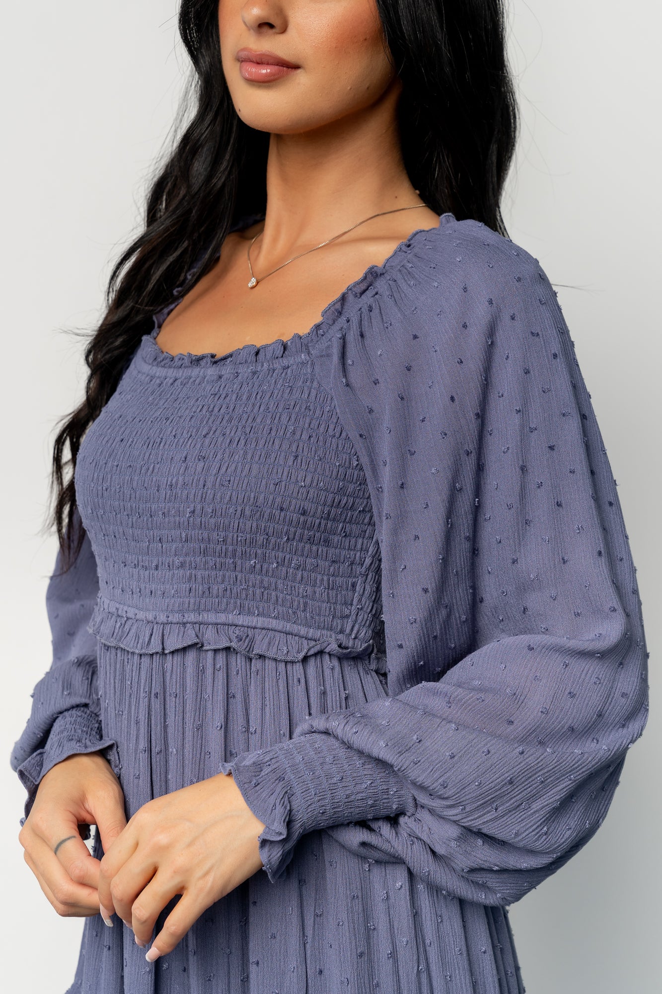 Back and side view of Amanda smocked dotted maxi dress in dusk blue, illustrating the maxi length and partially lined skirt.