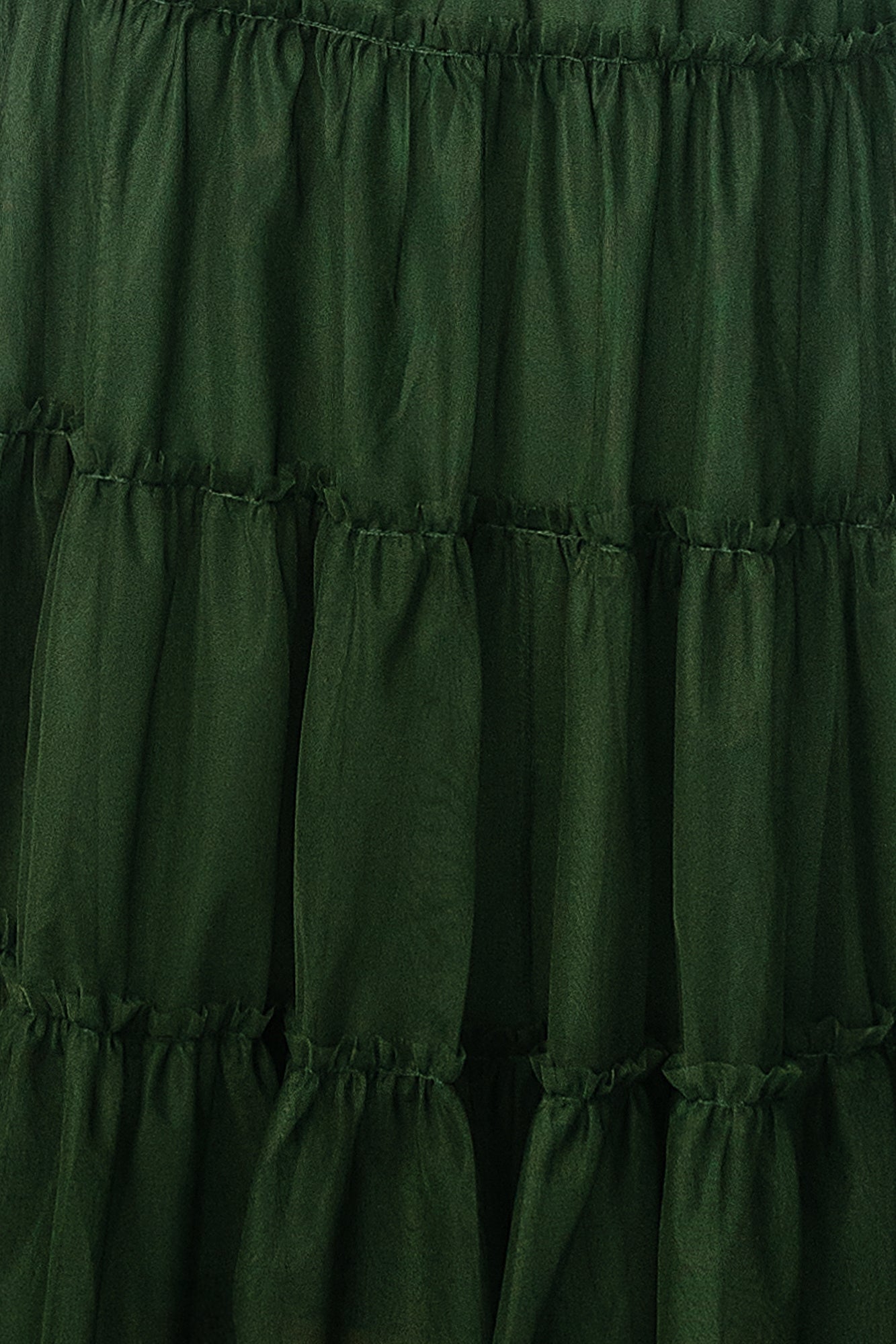 Close-up of Emma Tulle fabric swatch in Green, approx. 3 x 4 inches, showing sheer tulle texture and subtle color depth.