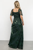 Back view of the Karina sequin maxi dress showing smocked back bodice, elastic back waist, and the flowing maxi-length skirt.