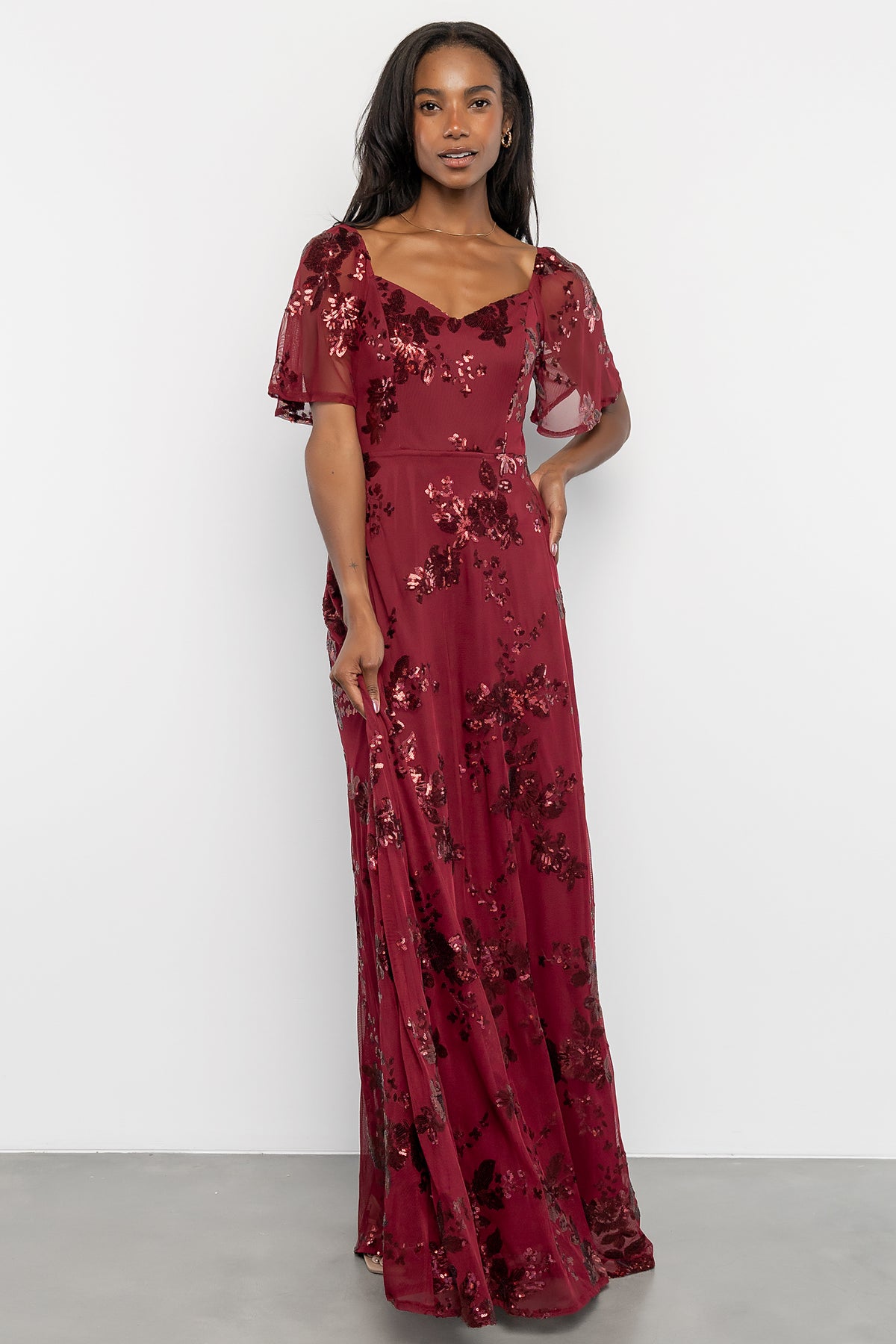Front view of Karina sequin maxi dress in wine with floral sequin overlay, sweetheart neckline, and flowing skirt, on a white background.