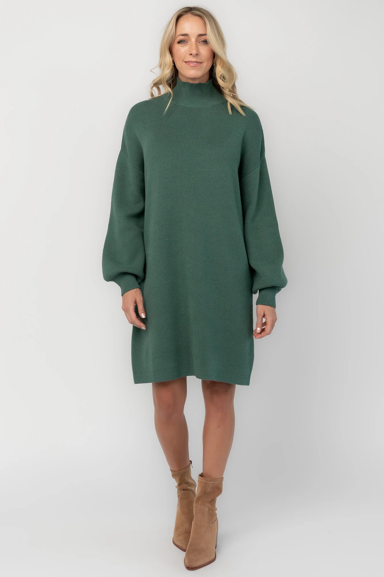 Evergreen knit sweater dress with a mock neckline, long balloon sleeves, dropped shoulders, and a relaxed above-the-knee silhouette.
