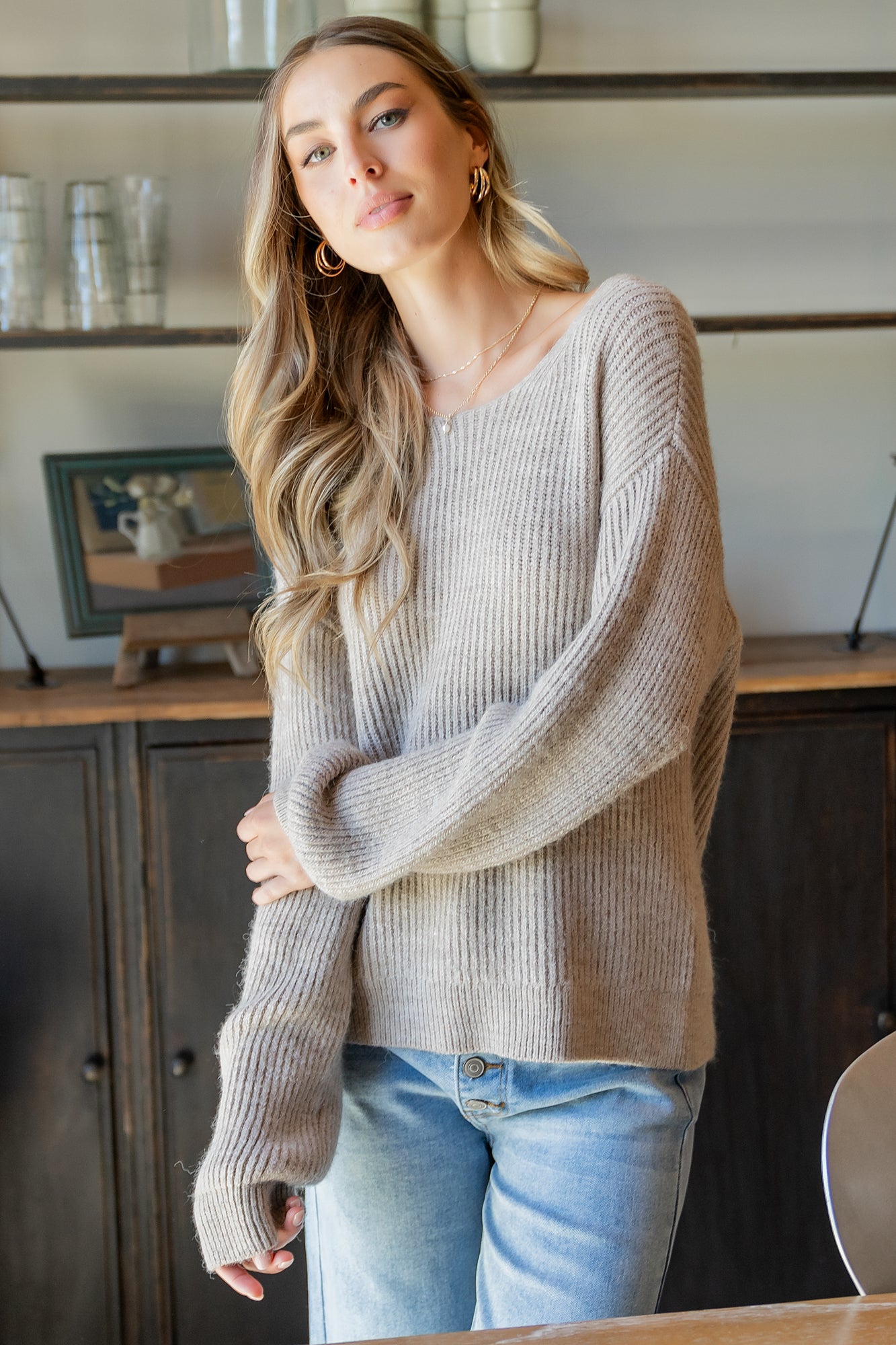 Styled flat-lay and detail composition featuring the Viola Tie Back Sweater in Natural alongside coordinating denim to illustrate outfit pairing ideas.