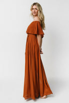 Close-up of elastic top hem and off-shoulder neckline detail on the Spice maxi dress, showing fabric texture and fit.