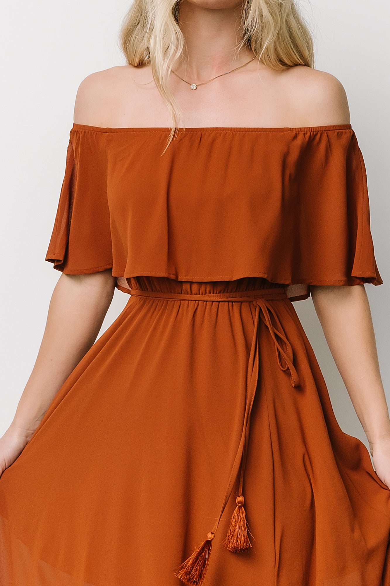 Back view of the Spice off-shoulder maxi dress showing elasticized shoulders and full-length flowing silhouette.