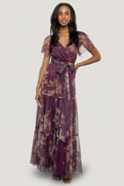 Full-length shot of the tiered maxi skirt in motion, emphasizing flow, volume, and the raw hemline for an elegant silhouette.