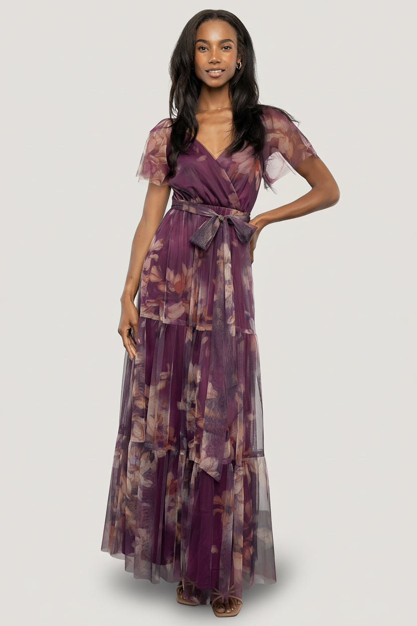 Full-length shot of the tiered maxi skirt in motion, emphasizing flow, volume, and the raw hemline for an elegant silhouette.