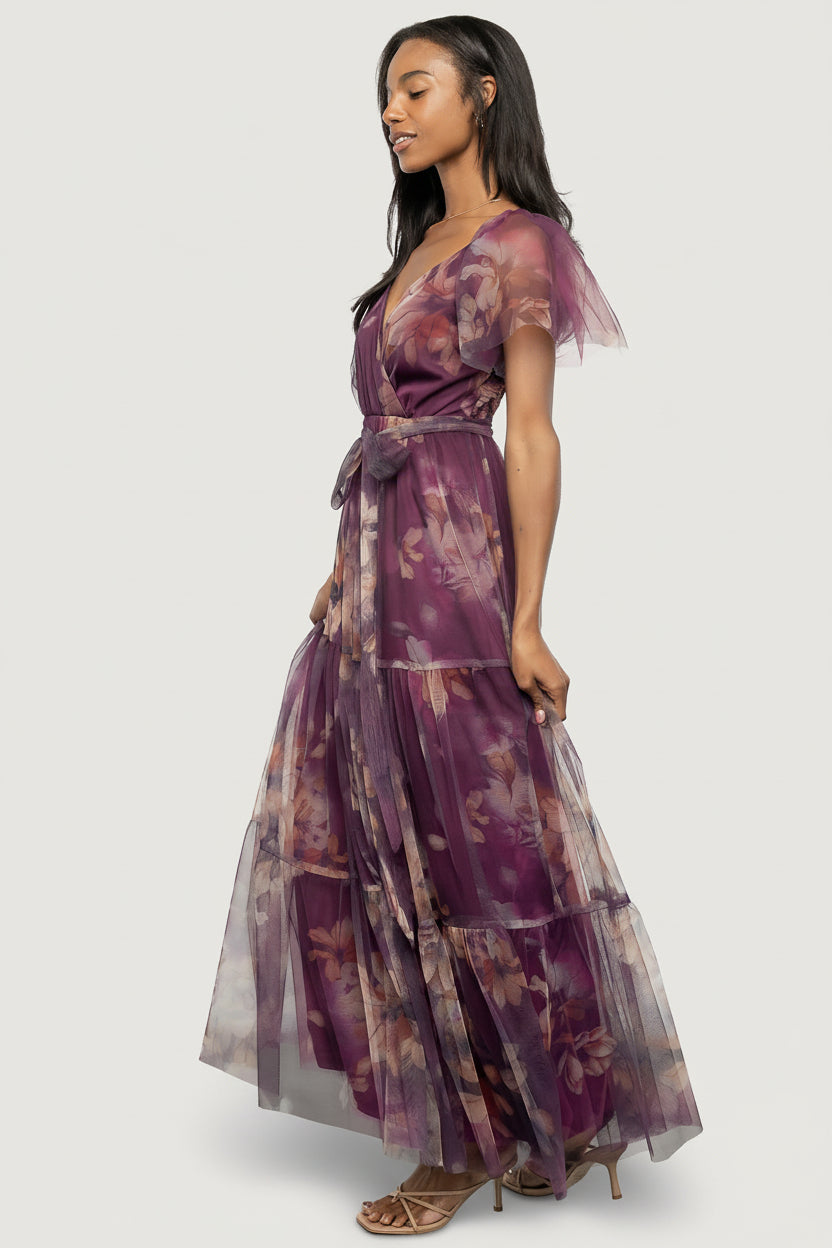 Back view of the maxi dress showing smocked back bodice, elastic at back waist, and the removable self-tie belt tied loosely.