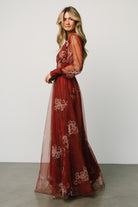 Model movement shot in the Layla rust floral maxi dress, showing flowing layered tulle skirt and natural drape of the fabric.
