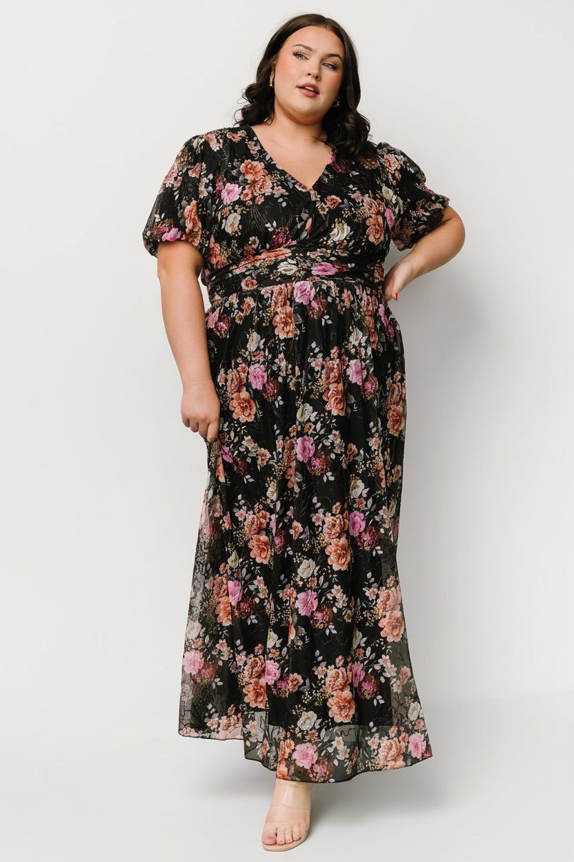 Front view of Ardley Maxi Dress in black multi floral showing V-neck, short puff sleeves, embroidered mesh overlay, and flowing maxi skirt.