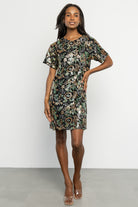 Three-quarter view of Squires sequin short dress showing fitted bodice, short skirt length, and multicolored floral sequin pattern on black mesh.