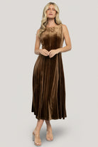 Front view of model wearing the Annika Bronze velvet midi dress with round neckline, wide tank straps, and mid-calf length silhouette.