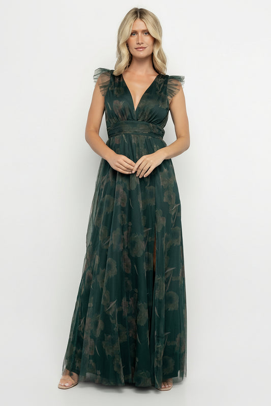 Model wearing Adelyn Maxi Dress in green floral tulle, front view showcasing deep V-front, flutter tank sleeves, and banded waist detail.