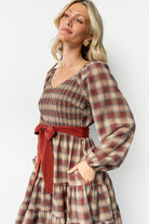 Three-quarter view of Stina Plaid Dress as model turns; highlights hidden side pocket, plaid pattern, and soft cotton-blend fabric drape.