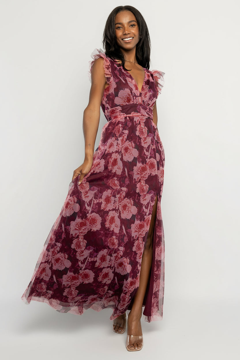 Back view of Adelyn Maxi Dress in Wine Floral showing the deep V-back, elasticized back waist, and flowing tulle skirt with left leg slit.