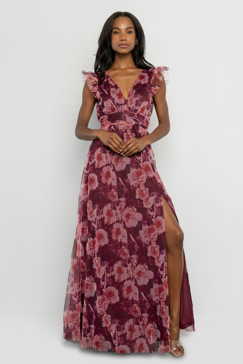 Model wearing Adelyn Maxi Dress in Wine Floral, front view showing deep V-neckline, flutter tank sleeves, and banded waist for a romantic silhouette.