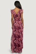 Styled flat-lay of the Adelyn Maxi Dress in Wine Floral showing full silhouette, deep V-front, banded waist, and tulle overlay over lining.