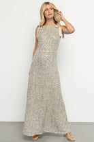 Full-length side view of Saya sequin maxi gown in champagne showing hidden side zipper, elastic waistband, and sequin texture.