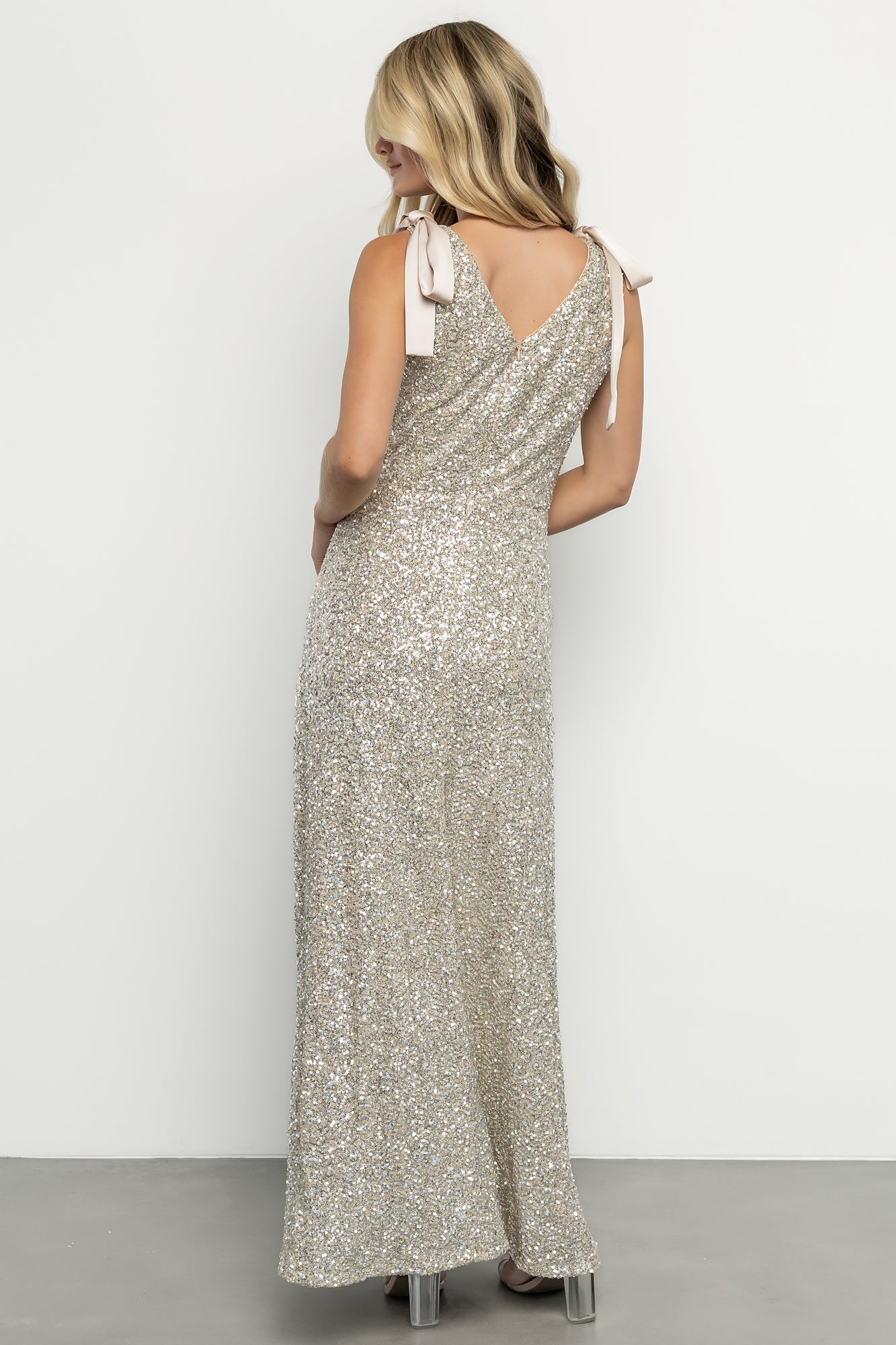 Styled look of the Saya sequin maxi dress paired with minimal accessories, highlighting movement and evening-ready sparkle.