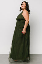 Model walking in Juniper Green Kamila Tulle Maxi Dress, skirt motion visible with layered tulle and flattering V-neck profile on display.