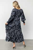 Side view of the Rayna Smocked Maxi Dress showing tiered skirt movement and mid-weight fabric texture in blue floral.