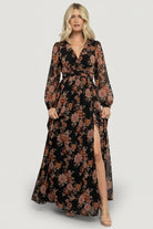 Styled look of the Adira Maxi Dress in black with mauve florals, paired with neutral accessories to show full maxi silhouette.