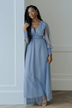 Front view of Layla Tulle Maxi Dress in whisper blue on model, showing flowing tulle skirt, plunging V-neck, and smocked waist for a flattering silhouette.