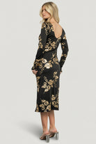 Close-up of the gold metallic floral pattern on black luxe knit, showing texture, metallic finish, and knit stitch detail.