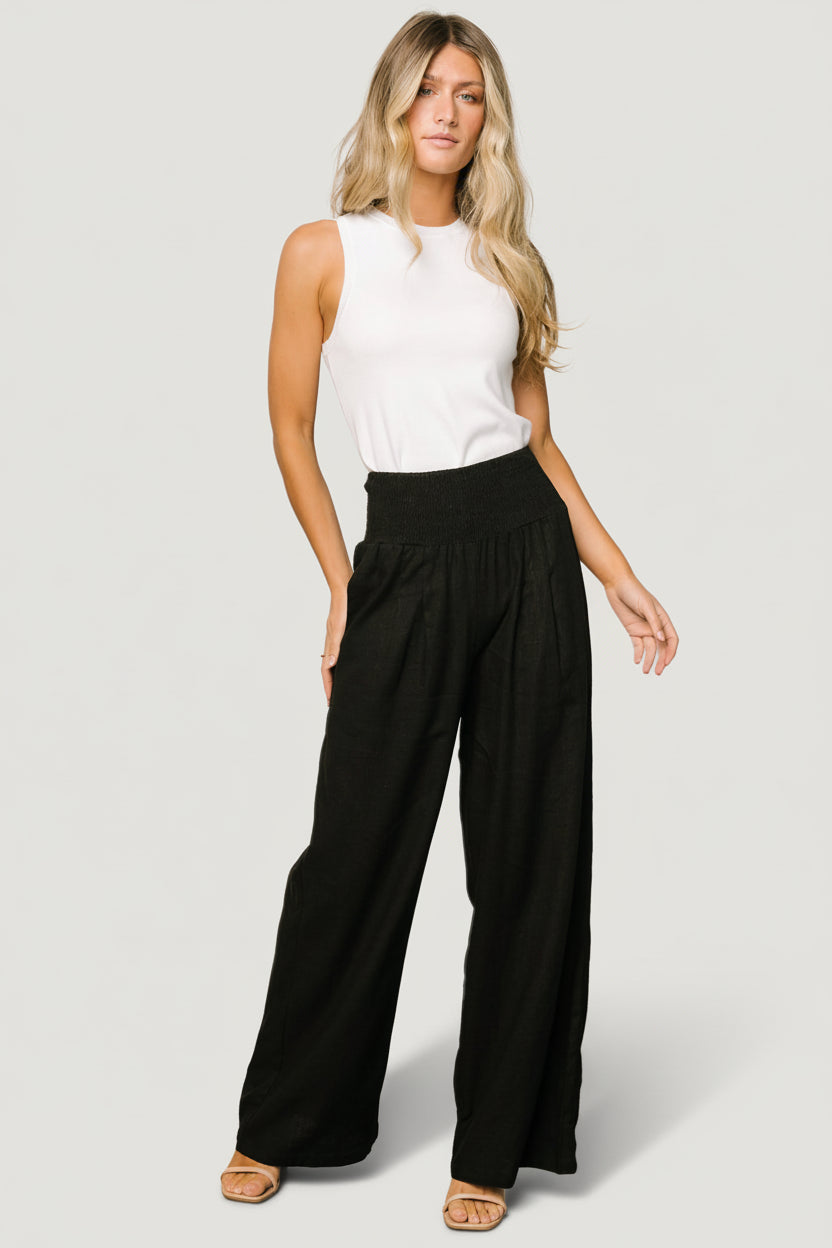 Close-up of the smocked high waistband and texture of the linen-rayon blend on a black Parvati pant.