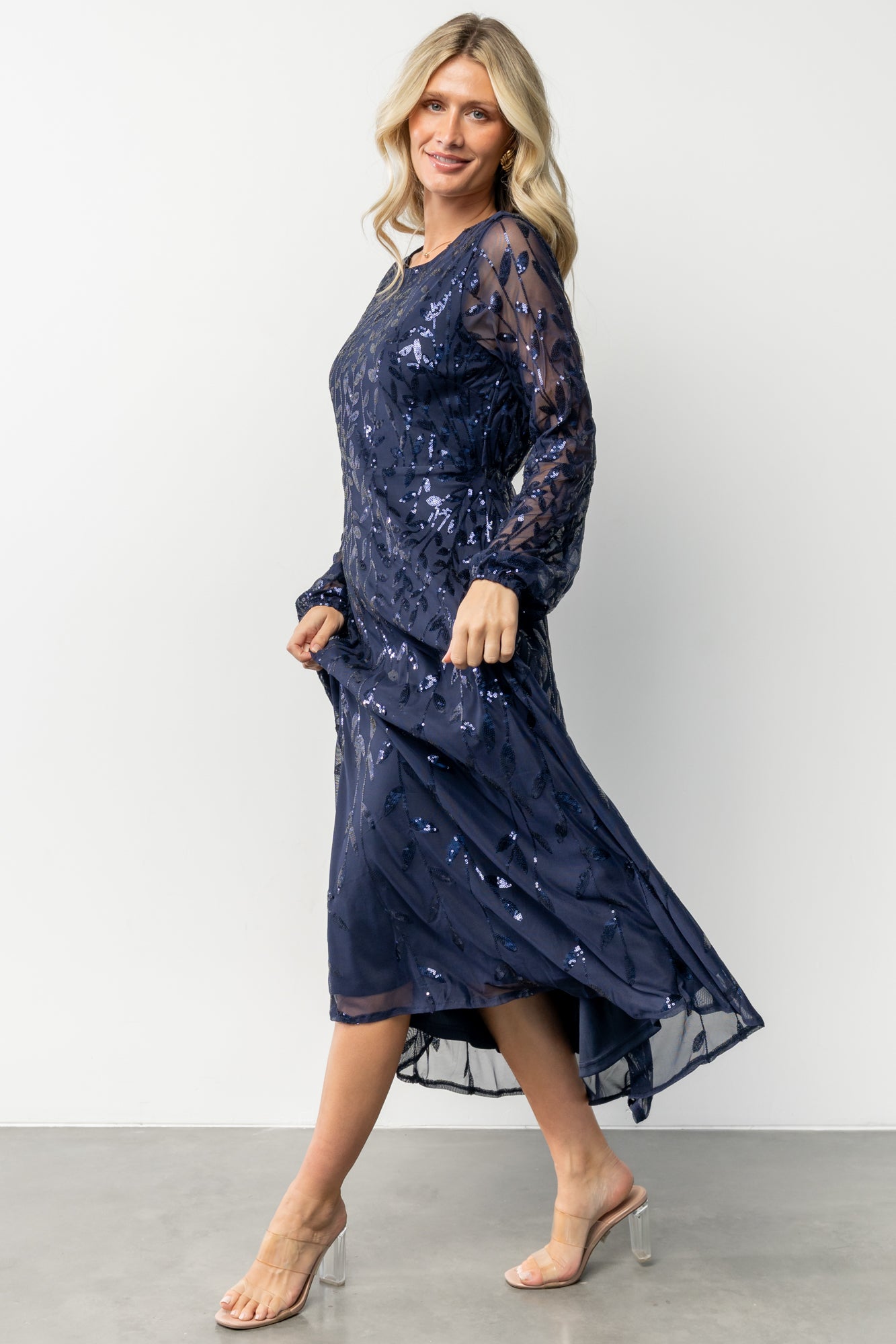 Studio shot of the dress fabric and lining edge, illustrating that the body is fully lined while sleeves remain sheer mesh.