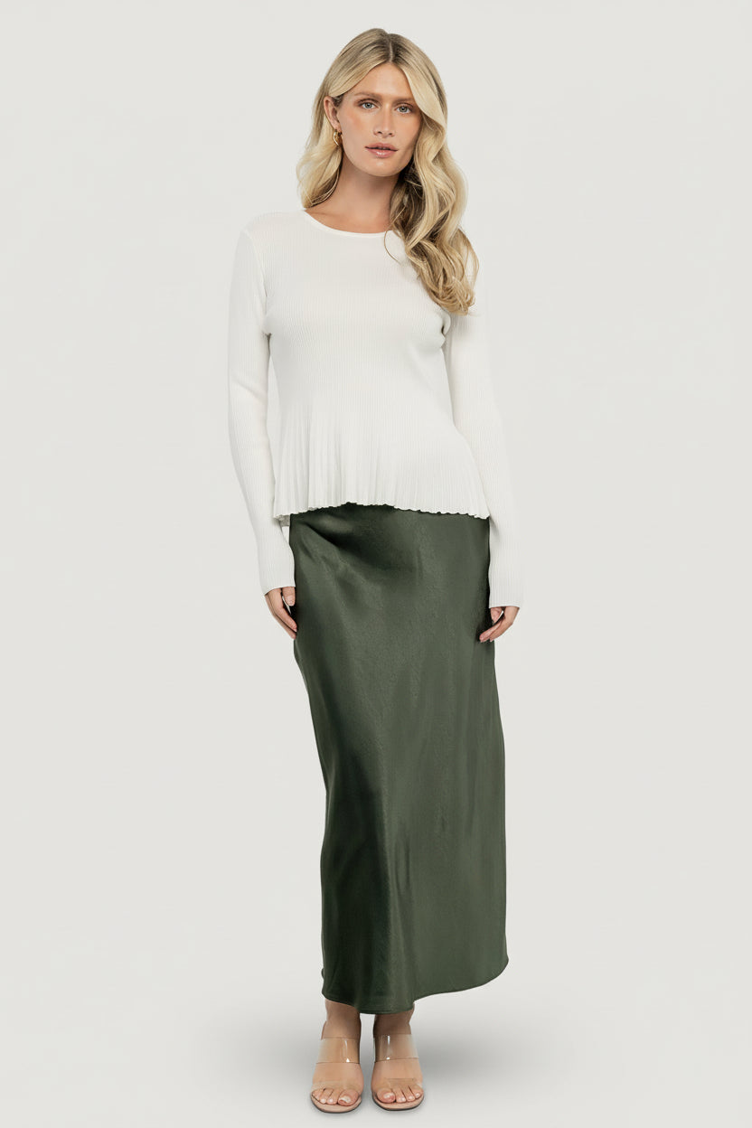 Styled outfit photo featuring the off-white Ainsley Ribbed Top paired with a satin midi skirt to show versatile day-to-night styling.