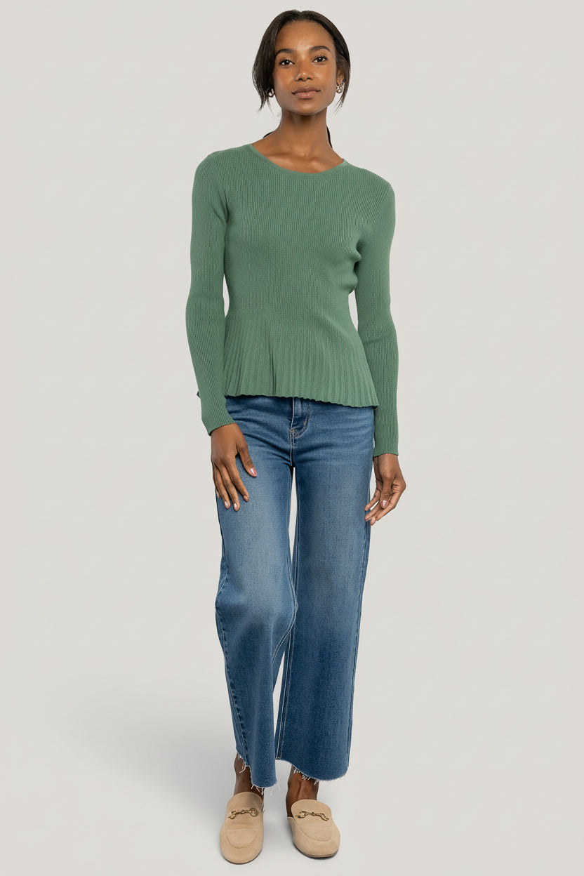 Side profile of the fitted ribbed top highlighting the peplum silhouette and comfortable stretch knit fabric in winter green.