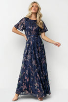 Model wearing Muse Sequin Maxi Dress in dark blue multi on a neutral background, showcasing full length, movement, and sequin embellishment.